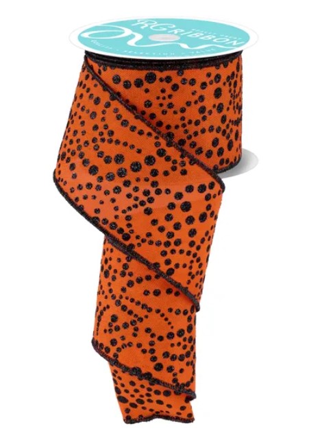 a spool of orange and black polka dot ribbon.