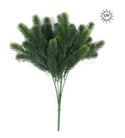 A bunch of green pine needles or branches, possibly artificial, arranged in a cluster.