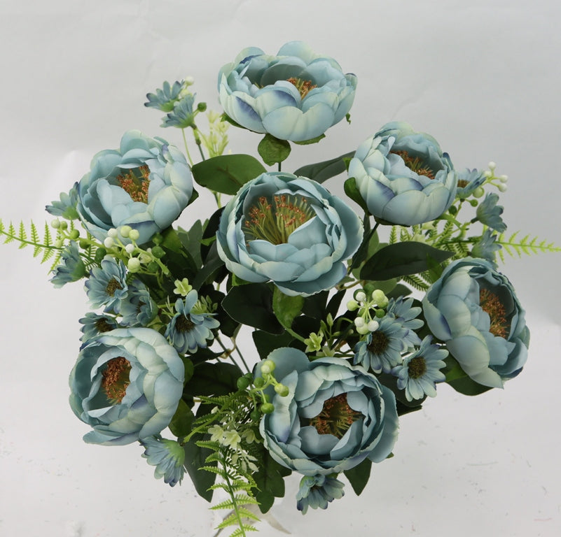 a vase filled with blue flowers on top of a table