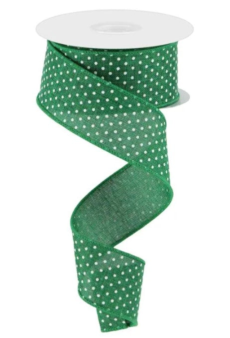A green and white polka dot ribbon is shown, with the ribbon winding around a white spool.
