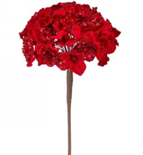 A tall, slender brown stem supports a large, vibrant bouquet of red flowers with a shiny, glittery appearance.