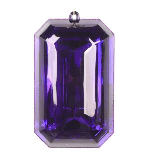 A large, purple gemstone with a clear, reflective surface.