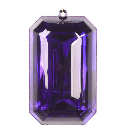 A large, purple gemstone with a clear, reflective surface.