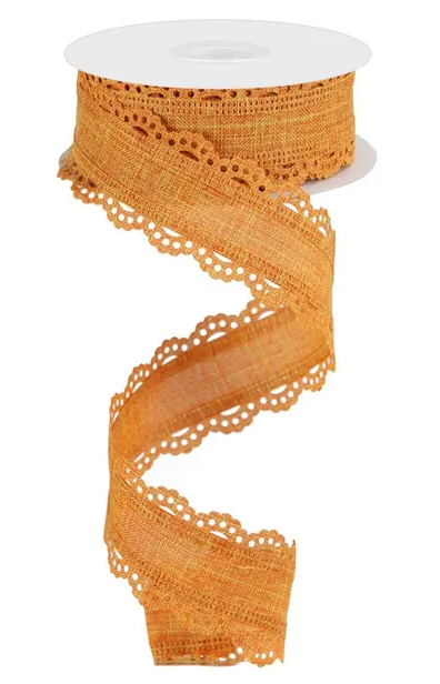 A spool of orange, lace-like fabric ribbon is shown against a white background.