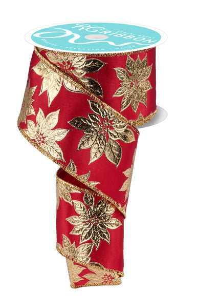 A red ribbon with gold leaf patterns, sitting on a white surface.