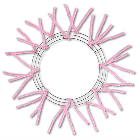 a circular frame made of pink pipe cleaners arranged in a radial pattern.