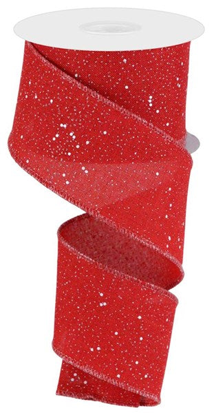 A red, sparkly, and white-spotted ribbon is coiled and attached to a white spool.