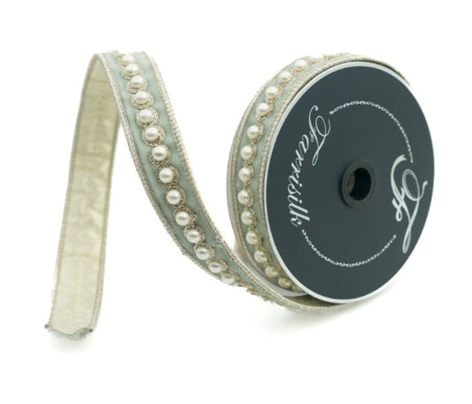 A roll of decorative ribbon with a beige and white color scheme, adorned with small pearls and a black and white logo.