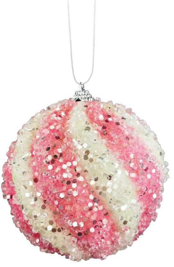 a pink and white ornament hanging from a string