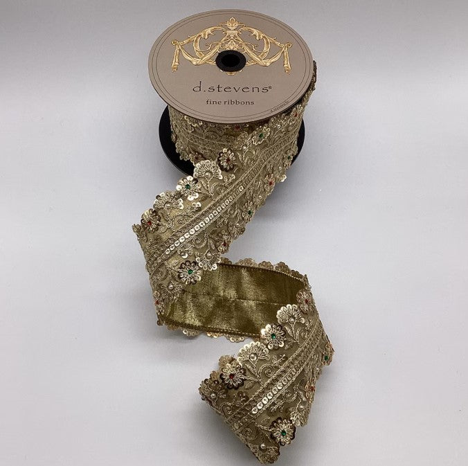 A roll of gold-colored, ornate, and embellished ribbon with a decorative trim, placed on a plain background.