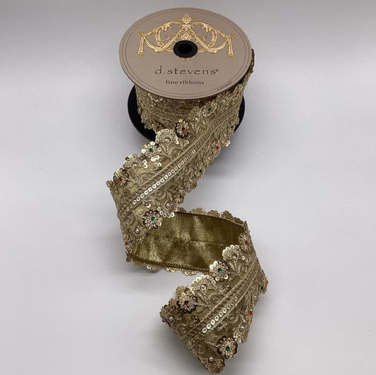 A roll of gold-colored, ornate, and embellished ribbon with a decorative trim, placed on a plain background.