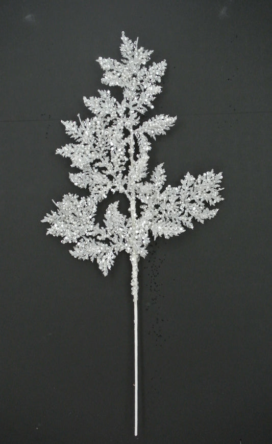 A delicate, white, snowflake-like branch with intricate, sparkling details is displayed against a dark background.