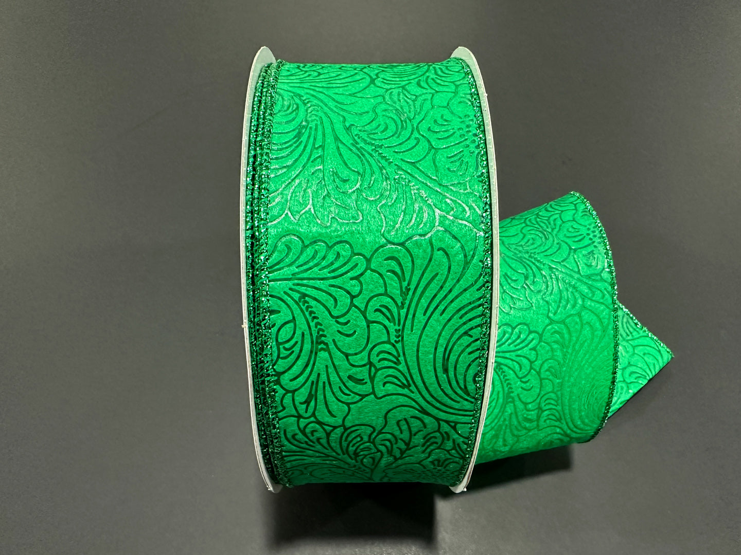 a close up of a green ribbon on a table