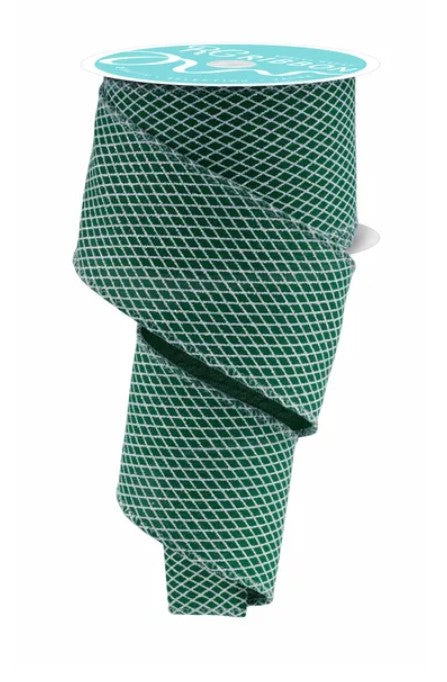 a green and white patterned fabric, possibly a ribbon, with a white label attached to it.