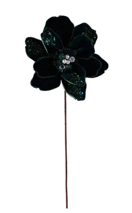 A single, dark green flower with glittering accents on its petals.