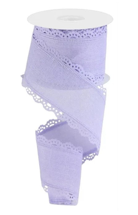 A roll of purple ribbon with a scalloped edge and lace-like patterns.