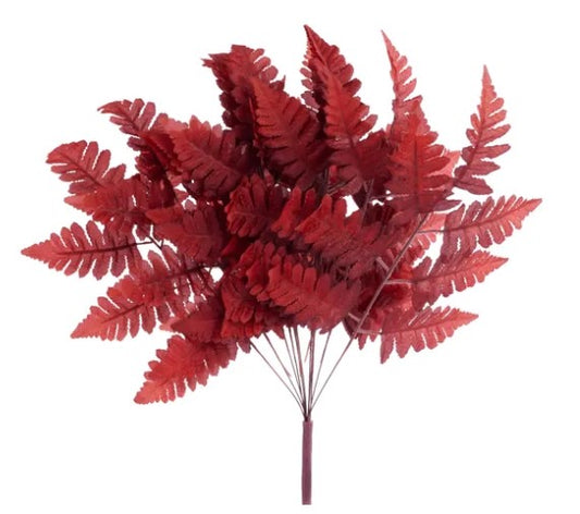 A bouquet of red fern leaves against a white background.