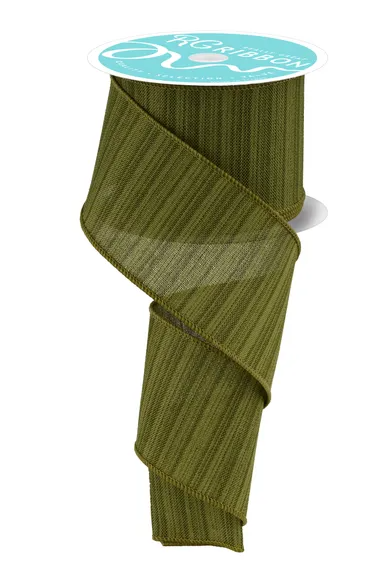 a roll of green ribbon with a white label on top.