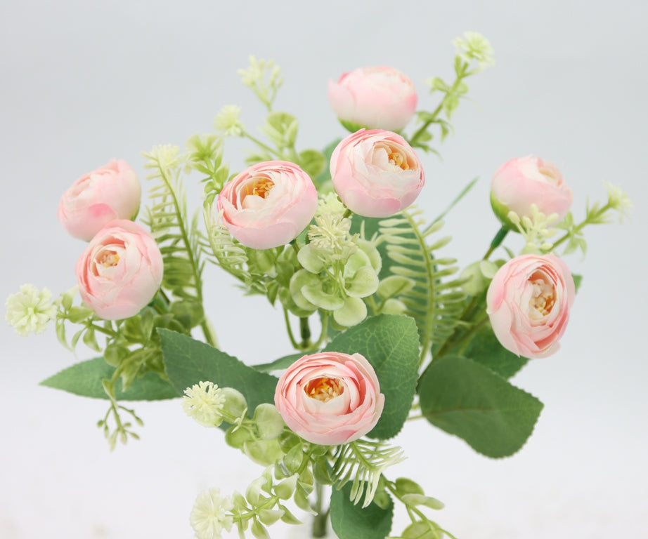 a vase filled with pink flowers and greenery