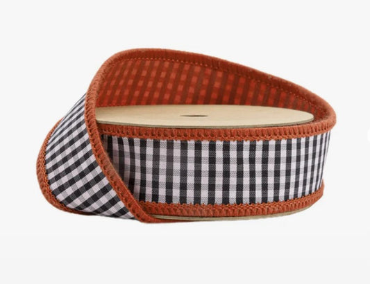 A roll of black and white checkered ribbon with an orange border.