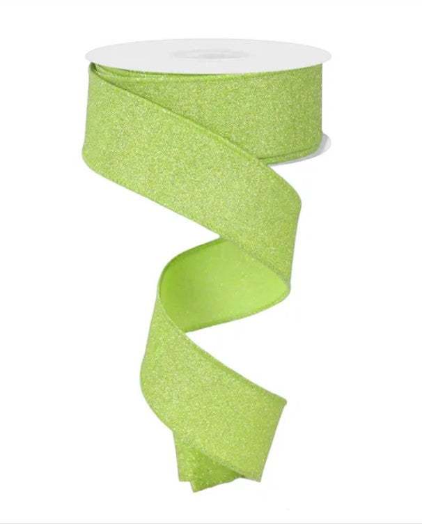 A roll of neon green glittery ribbon is shown against a white background.