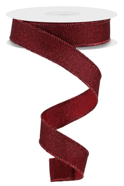 a roll of red glitter ribbon on a white background