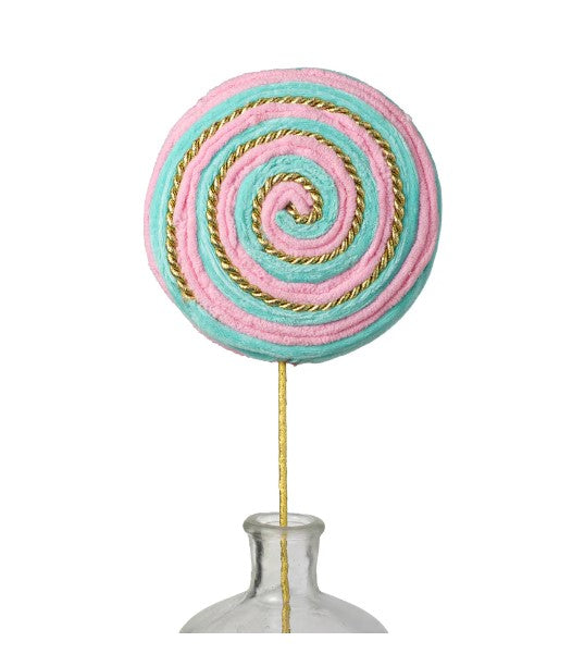 a candy lollipop sitting on top of a metal vase