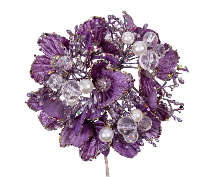 a brooch with purple flowers and pearls