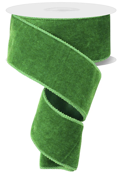 A roll of green velvet ribbon with a white base.