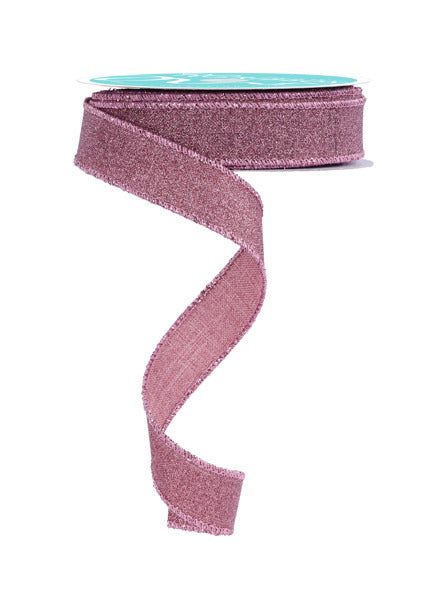 a roll of pink glitter ribbon on a white background