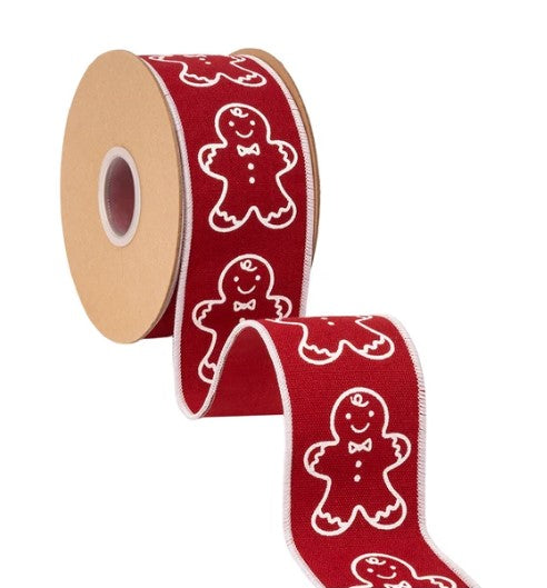 A roll of red ribbon with white gingerbread man designs on it.