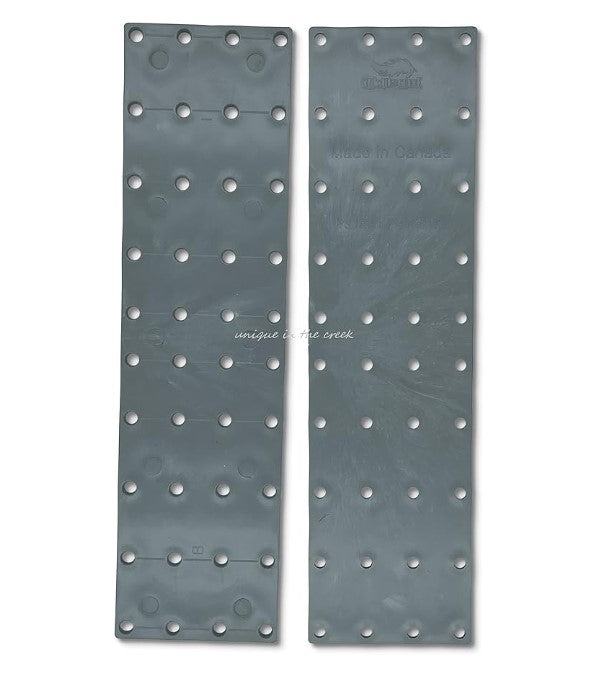 two gray metal plates with numerous small holes arranged in a grid-like pattern.
