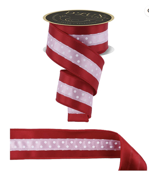 a red and white polka dot ribbon with a black and gold label.
