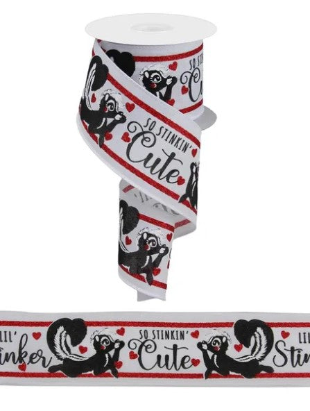 A white ribbon with a repeating pattern of black and red images of a skunk, along with the text "So Stinkin' Cute" printed on it.
