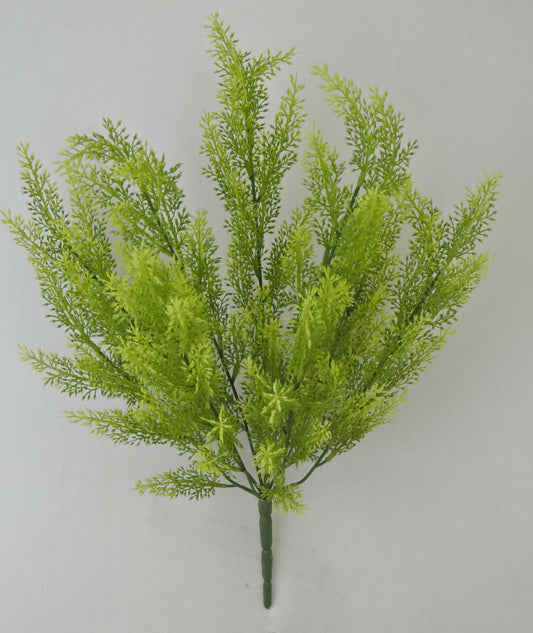 A green artificial plant with long, thin leaves arranged in a cluster.