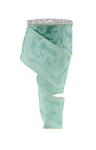 a roll of light green satin ribbon on a white background