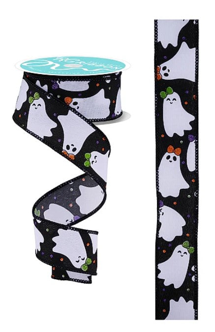 a spool of ribbon with a black and white ghost pattern and a green bow on top.