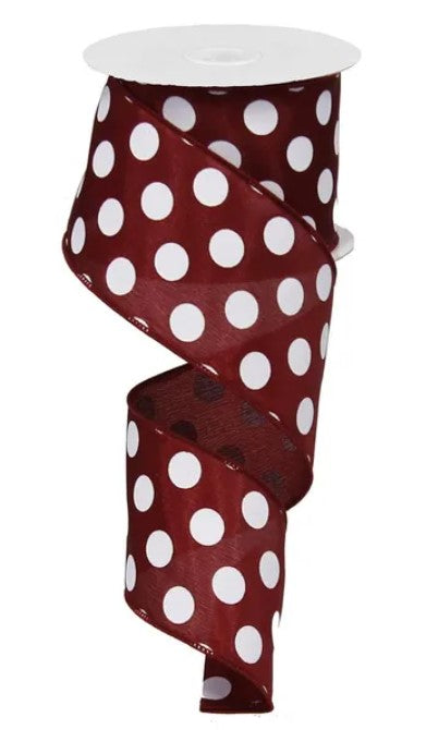 A spiral-shaped red ribbon with white polka dots.