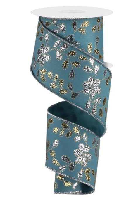 A turquoise ribbon with a silver glitter pattern, featuring a repeating floral design.