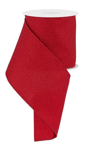 a roll of red ribbon on a white background