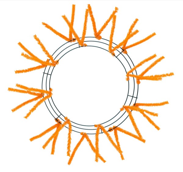 a circular wreath made of orange pipe cleaners arranged in a circular pattern.