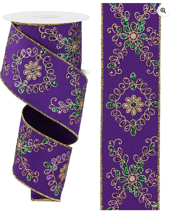 two purple ribbons with gold and green floral designs. The ribbons are adorned with intricate patterns and appear to be embellished with glitter or sequins.
