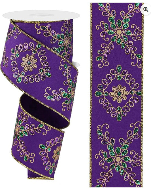 two purple ribbons with gold and green floral designs. The ribbons are adorned with intricate patterns and appear to be embellished with glitter or sequins.