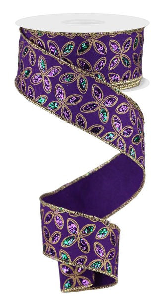 a purple ribbon with green and purple sequins on it