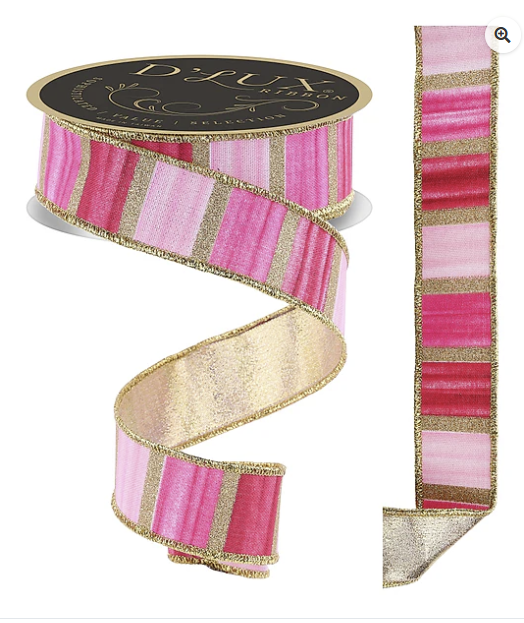a pink and gold decorative ribbon with a black and gold label.