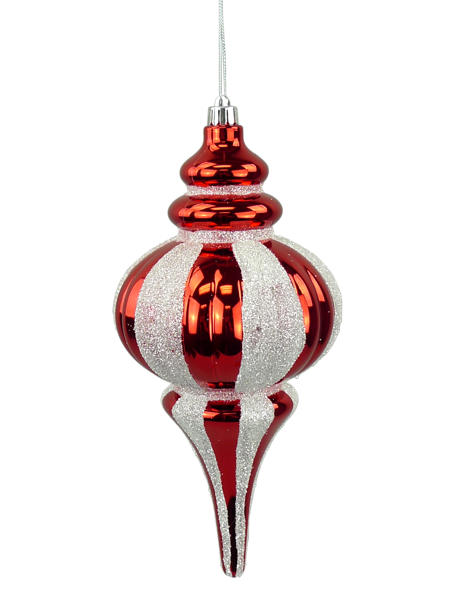 A red and white striped ornament with a pointed top and a long, thin body is suspended from a string.