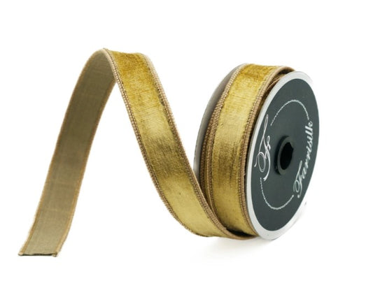 A gold-colored ribbon is coiled and lying on a white background.