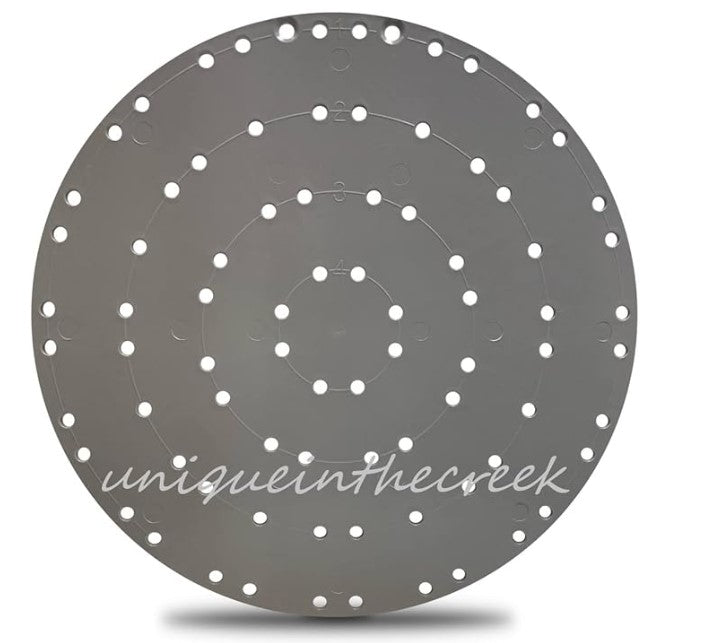 a circular object with a pattern of small white dots arranged in concentric circles, creating a visually striking design.