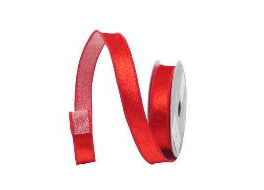 A red ribbon is coiled and attached to a spool of ribbon, creating a decorative and festive appearance.