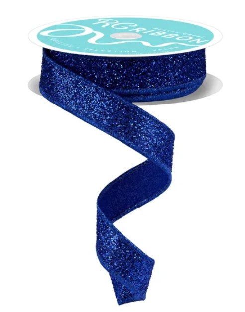 A roll of blue glittery ribbon with a white label on top.